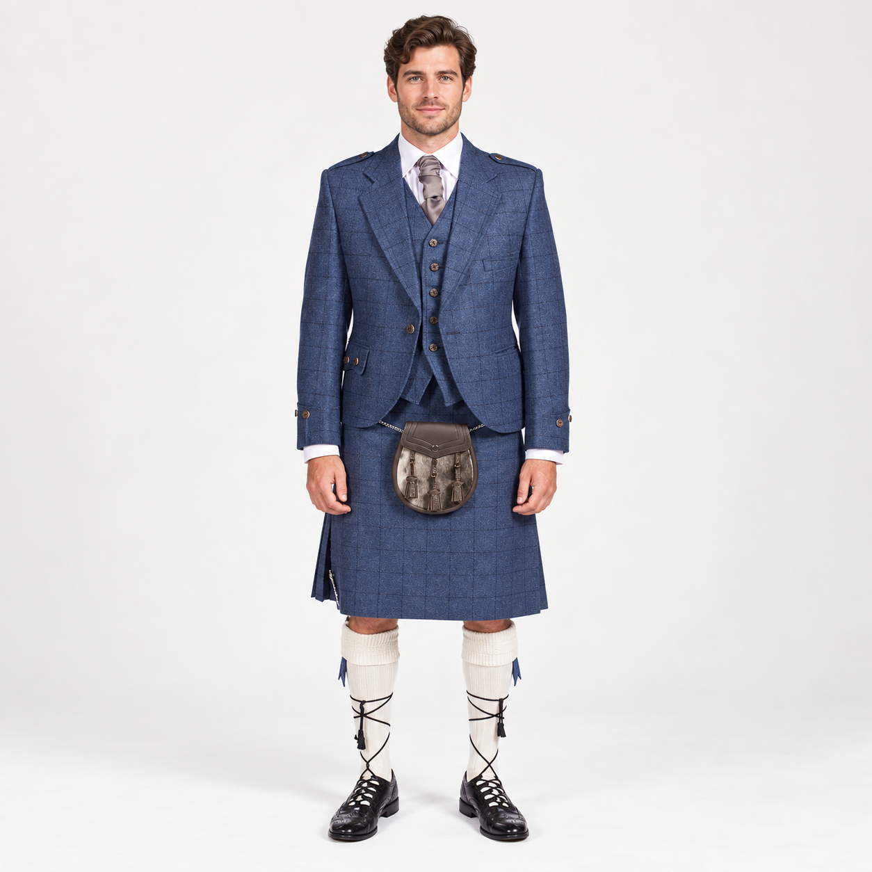 Front view of a men’s blue tweed Argyle jacket and matching kilt outfit with waistcoat, tie, sporran, cream kilt hose and black ghillie brogues.